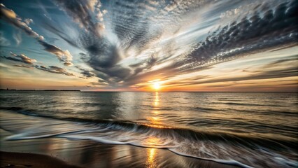 Breathtaking Long Exposure of a Vibrant Sunset Over Calm Sea Waters with Dramatic Sky Colors and Gentle Waves