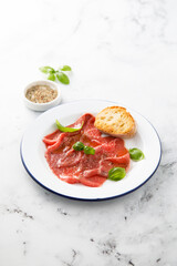 Traditional beef carpaccio with salt and pepper