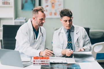 Group of medical practitioners working together and analyzing medical scan in the hospital