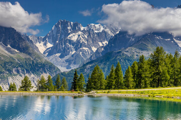 Obraz premium Lake in the Alps. Mountain lake high altitude lagoon surrounded with mountain peaks picturesque landscape of alpine scene in summer. Turquoise water of lagunas in french and italian Alps