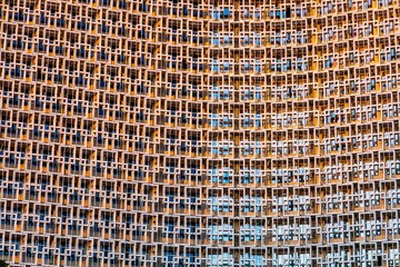 A grid of windows of a skyscraper building in the form of an abstract pattern with an interesting design.