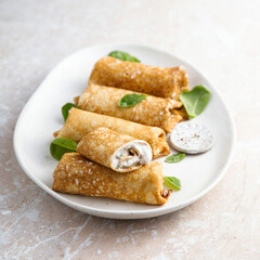 Crepes with creamy filling and raisins