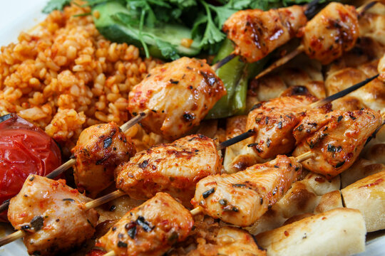 Chicken shish kebab on a serving plate.
Served with salad and rice
