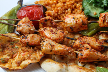 Chicken shish kebab on a serving plate.
Served with salad and rice

