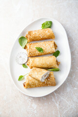 Crepes with creamy filling and raisins
