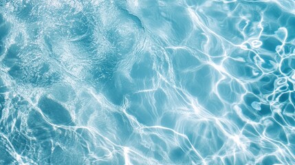 Fototapeta premium A serene view of crystal-clear swimming pool water, with small ripples forming as light dances across the surface,