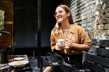 A young woman with an artificial limb sits in a cafe, holding a cup of coffee and savoring a quiet moment of joy and connection.