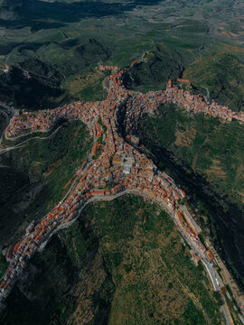 Aerial view of a beautiful village with residential homes and streets nestled in the mountains, Centuripe, Sicily, Italy.