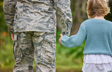 Back, family and child as soldier holding hands for return home, military welcome and reunion from army service. Parents, children and embrace with hero from war, bonding together and warrior safety