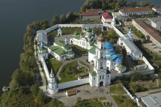 Aerial view of raifa monastery with white walls, green roofs, and domes by a serene lake, Raifa, Russia.