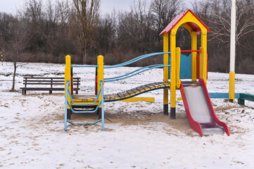 playground in winter, snow on the ground, nobody