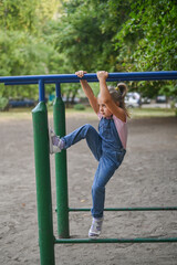 Obraz premium A girl is playing on the uneven bars. the concept of active recreation and sports.