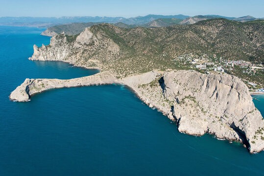 Aerial view of beautiful rocky coastline and serene blue sea, Novyi Svit, Crimea, Russia.