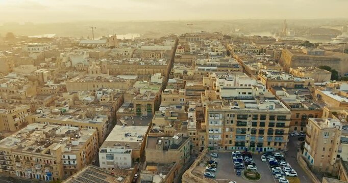 Aerial view sunset in the cityscape of Valletta Malta. Beautiful urban landscape of tourist streets in a historic Mediterranean city with ancient architecture. High quality 4k footage