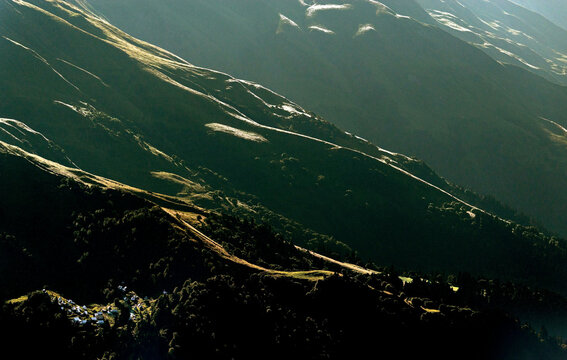 Aerial view of majestic mountains and a serene valley with lush greenery, Krasnaya Polyana, Russia.