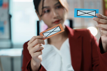 Businesswoman holding two paper envelopes, symbolizing comparing options for communication strategy...