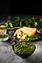 Homemade Pesto Sauce with Pine Nuts and Basil: Ingredients on Black Background