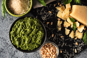 Homemade Pesto Sauce with Pine Nuts and Basil: Ingredients on Black Background