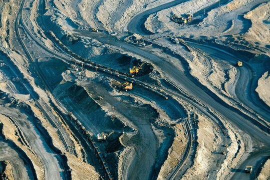 Aerial view of an industrial pit mine with heavy machinery and roads, Belgorod Oblast, Russia.
