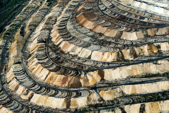 Aerial view of industrial pit mine with exposed layers and terrain, Belgorod Oblast, Russia.