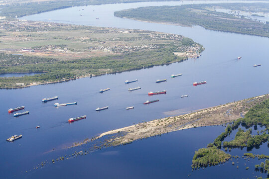 Aerial view of the beautiful Volga River with cargo ships and scenic landscape, Volgograd Oblast, Russia.