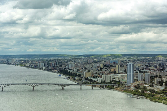 Aerial view of beautiful cityscape with modern architecture and a bridge over the Olga River, Saratov, Russia.