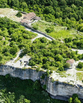 Aerial view of the grand canyon of Crimea with lush greenery, cliffs, and a winding road, Bakhchysarai Raion, Russia.