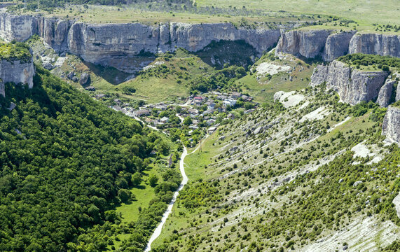Aerial view of the beautiful Grand Canyon of Crimea with lush greenery, cliffs, and a winding road, Bakhchysarai Raion, Russia.