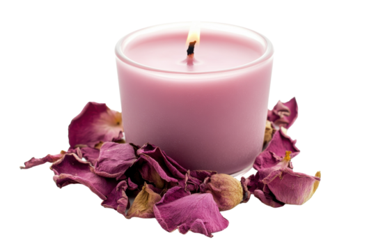 A soothing pink candle surrounded by dried rose petals on a soft, white background