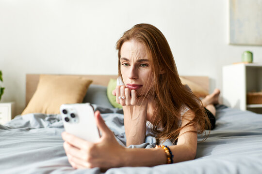 A young woman rests on her bed, deep in thought as she engages with her phone, navigating her struggles.