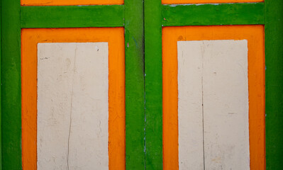 primer plano de puerta r&uacute;stica en madera y pintada de colores 