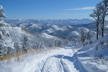 Fototapeta premium Snow covered hills under a blue sky, bright white snow, clear visibility