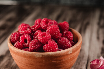 Fresh Raspberries: Juicy, Ripe Berries for a Healthy Summer Snack on a Wooden Background