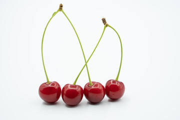 freshly picked fresh cherry grains next to each other, isolated on white background