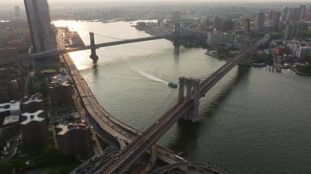 Aerial view of brooklyn bridge spanning the east river with a beautiful skyline and busy streets, new york, united states.