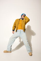 A young man with tattoos captures a vibrant moment while showcasing his urban style.