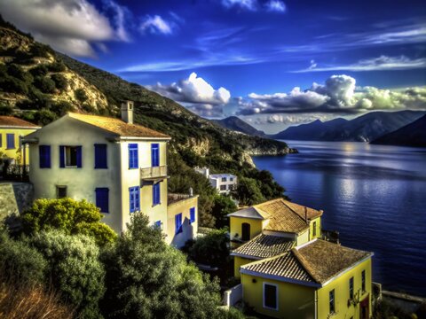 Scenic View of White Houses with Yellow Shutters Overlooking Mountains and Sea in Vuno, Albania