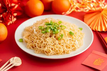 A beautifully arranged plate of noodles topped with fresh scallions, ideal for showcasing vibrant food presentation during festive occasions.
