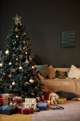 Vertical background image of festive home interior with Christmas tree and presents, copy space