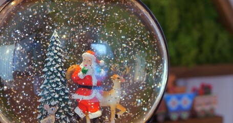 Snow globe with Santa and deer reflects cherished holiday memories, capturing essence of festive traditions and comforting warmth of Christmas celebrations at home. Christmas spirit concept