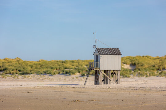 A wooden shelter on high stilts that stands on the North Sea beach (De Drenkelingenhuisje) The Dutch Wadden Sea island Terschelling, Municipality and an island in the northern, Friesland, Netherlands.