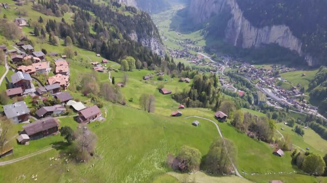Aerial view of picturesque village nestled in a lush valley surrounded by majestic mountains, Wengen, Switzerland.