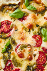 Puff pastry tart pizza with tomatoes, mozzarella cheese and pesto sauce. Galette Caprese