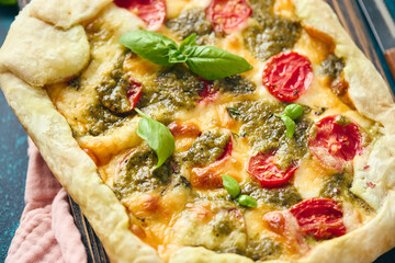 Galette-type pie made from puff pastry and filled with tomatoes, mozzarella cheese and pesto sauce. Galette Caprese