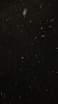 Abstract snowfall on black background, winter, falling snow.
