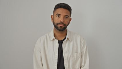 Handsome adult african man with beard wearing casual attire posing confidently against an isolated white background.