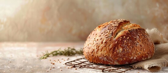 Artisan bread with seeds displayed on a cooking grid against a beige backdrop creating a rustic vibe with copy space image