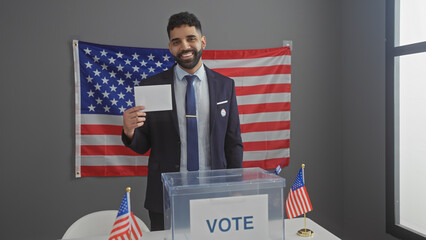 Handsome hispanic man with a beard smiling while voting in an american electoral college room with...