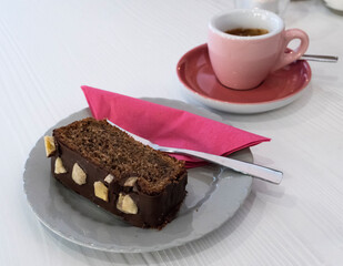 Bananen-Schokoladen-Kuchen und  Espresso, auf weißem Tisch,.