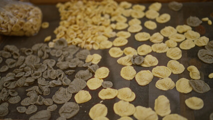 Authentic homemade orecchiette pasta drying outdoors in bari, puglia, italy, showcasing colorful...